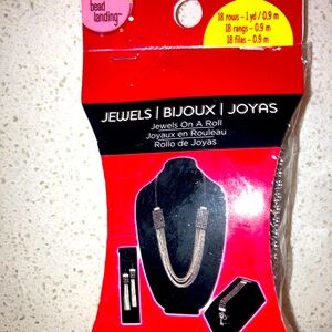 A box of mixed beads and jewelry charms.